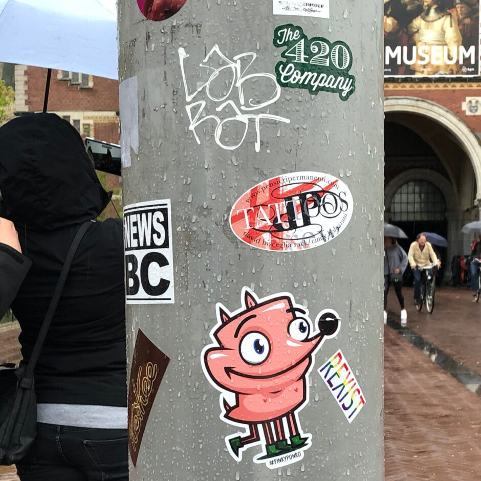 A post with multiple sticker in front of the Van Gogh museum in Amsterdam