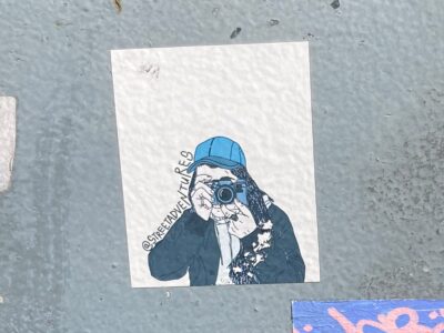 Illustration of a person taking a photo with an old photo camera