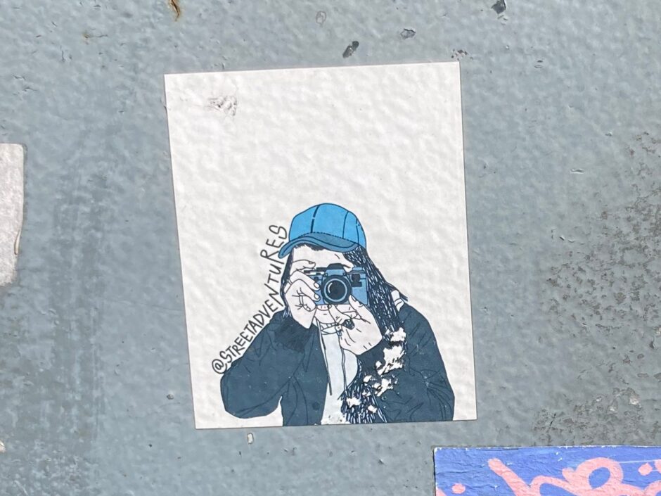 Illustration of a person taking a photo with an old photo camera