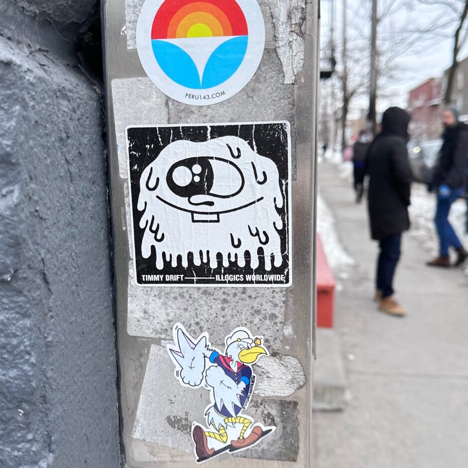 One eyed character illustrated on a square sticker