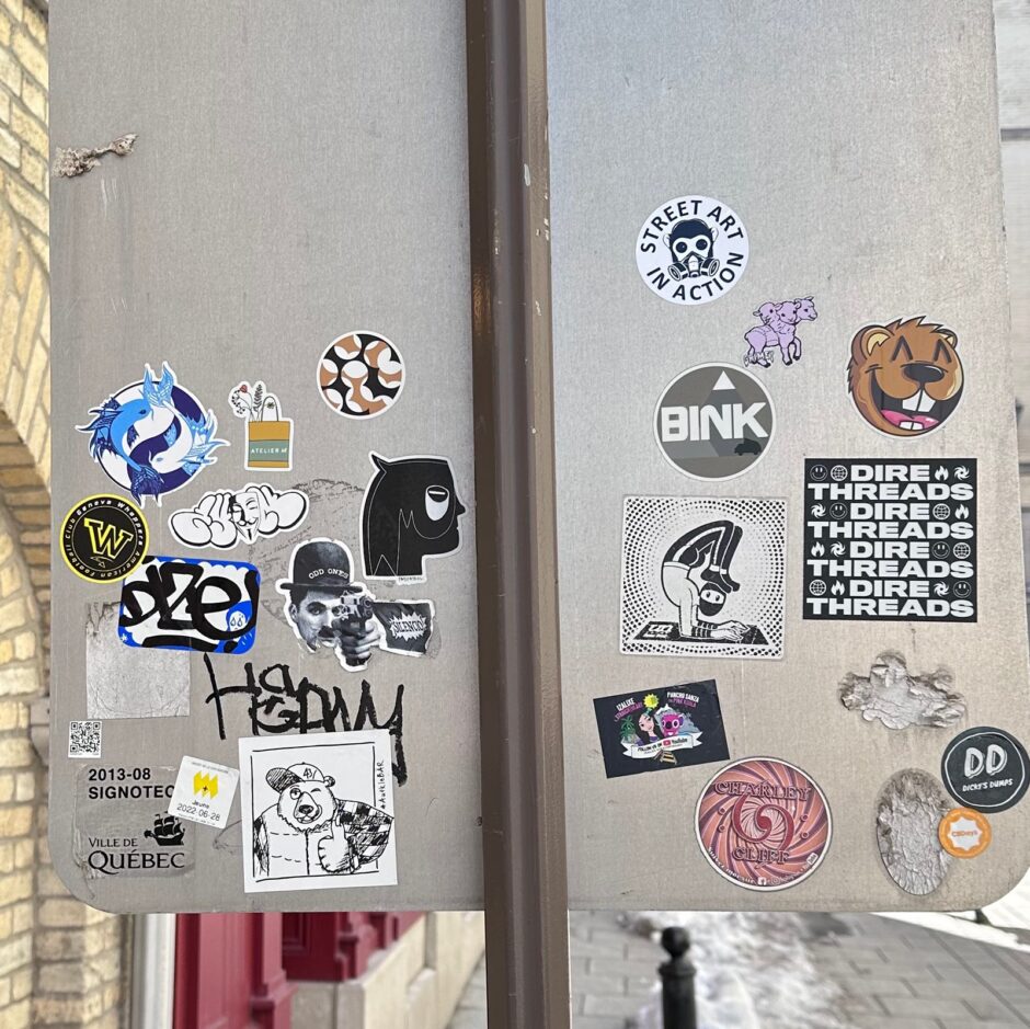 Collage of multiple sticker behind a street sign