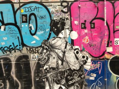 Giant black and white sticker of a geisha crying a riffle over an Hello Kitty backpack