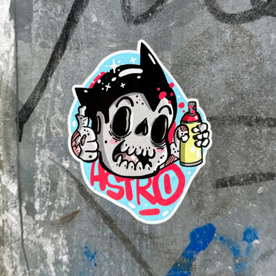 Astro Boy skull with spray paint can sticker