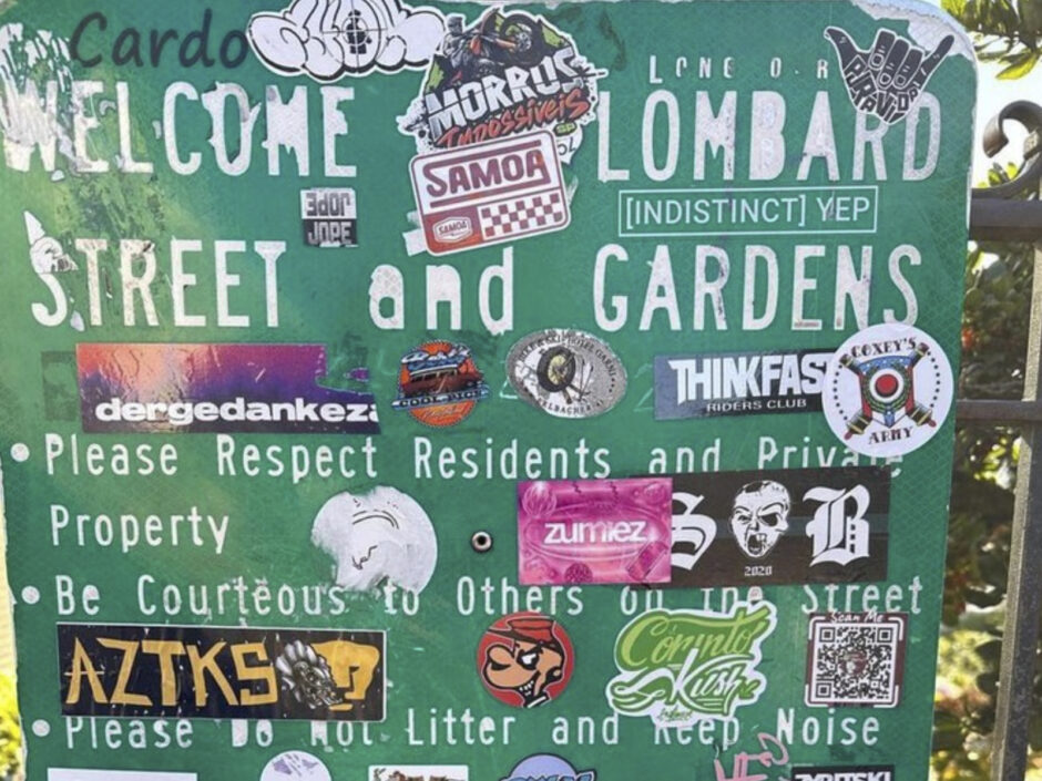 Multiple stickers on a park welcome sign