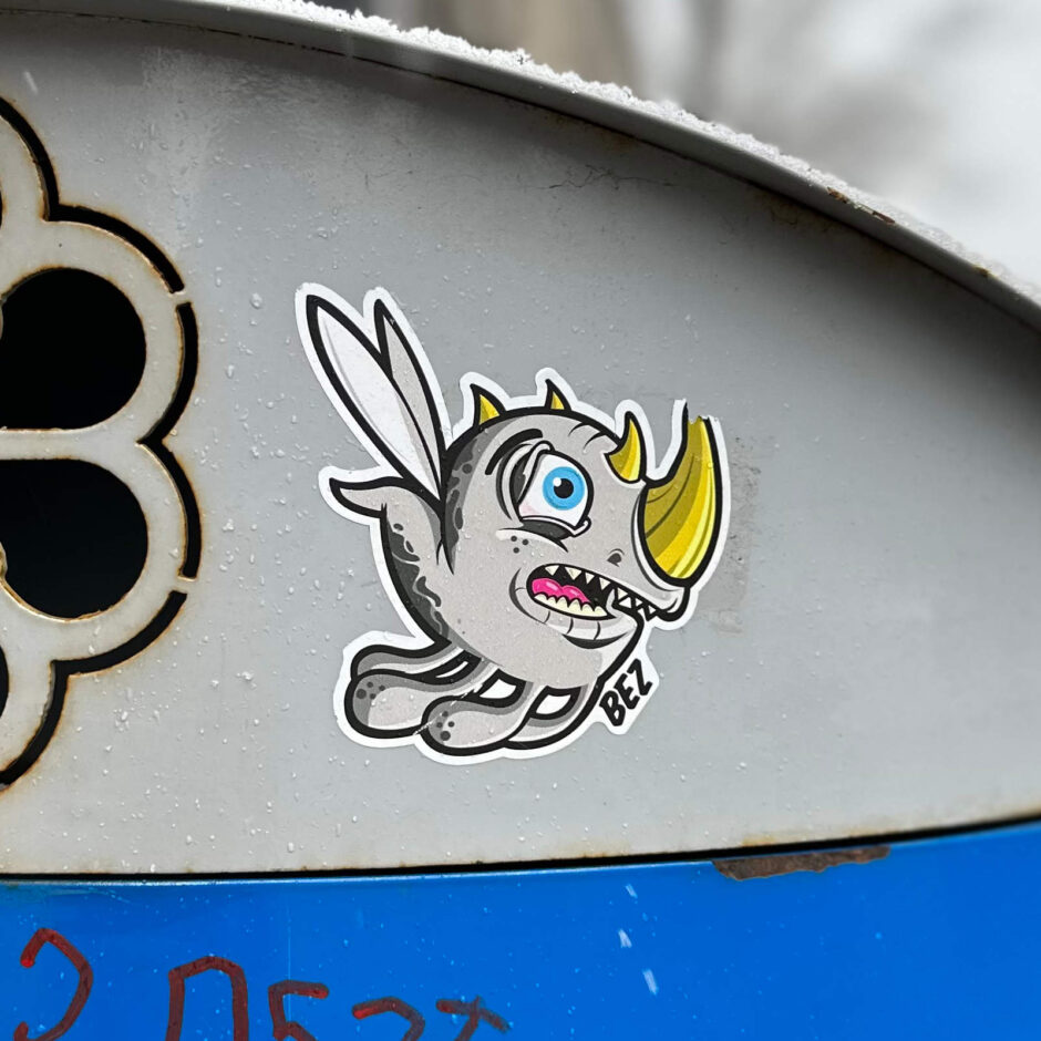 Flying creature sticker on trash can