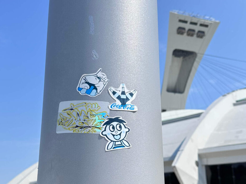 Stickers on a post at the Montreal olympic stadium