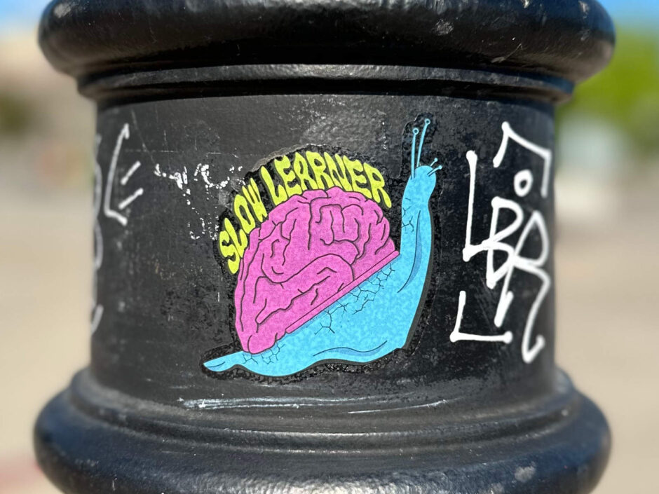 Colourful snail sticker on light post