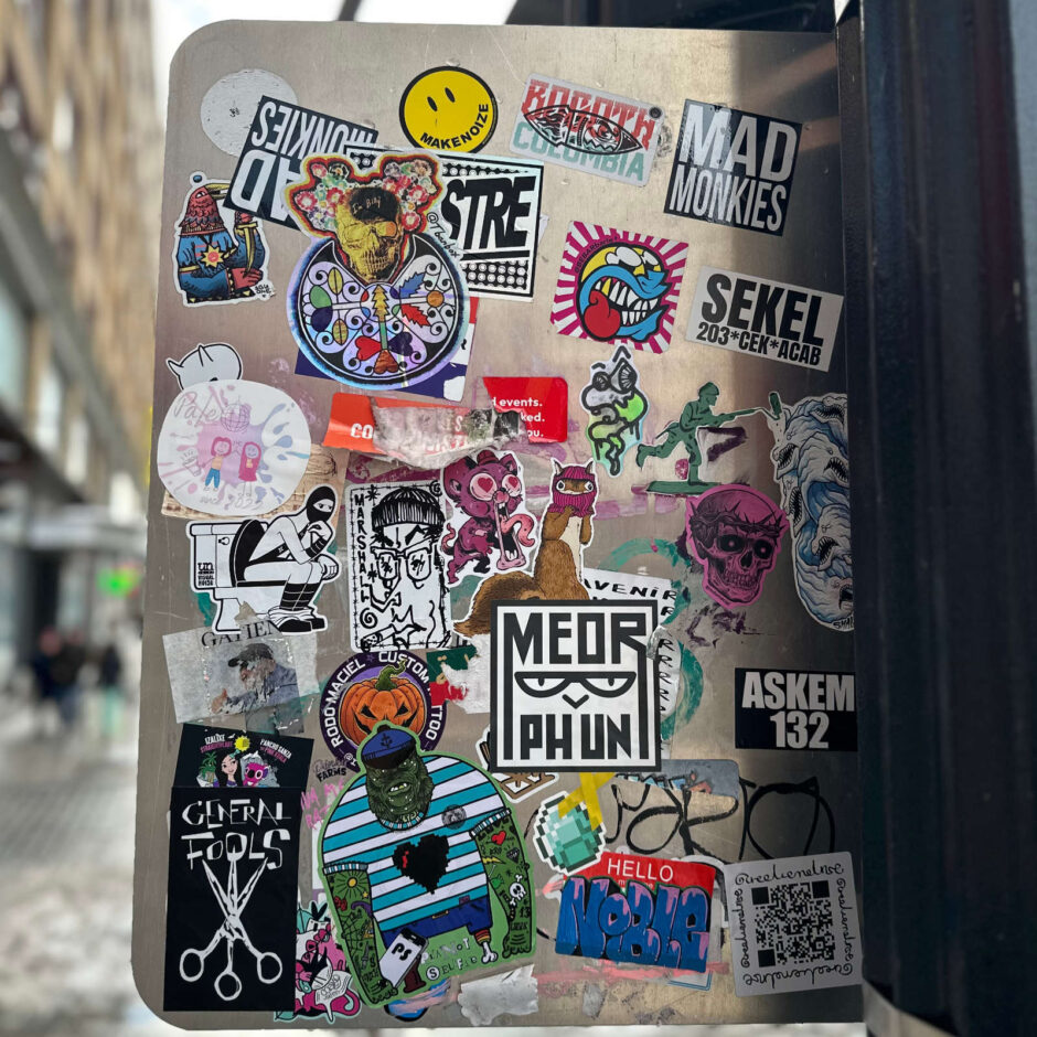 Street sign covered with stickers